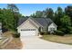 Inviting home with a two-car garage, a concrete driveway, and manicured shrubs and lawn at 4219 David Austin Ct, Snellville, GA 30039