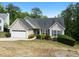 Well-maintained home on a lush, green lawn featuring a two-car garage and manicured landscaping at 4219 David Austin Ct, Snellville, GA 30039