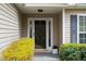 Inviting front entrance with a glass door, sidelights, and manicured landscaping at 4219 David Austin Ct, Snellville, GA 30039