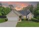 Attractive ranch-style home with lush green lawn and colorful sunset sky backdrop at 4219 David Austin Ct, Snellville, GA 30039