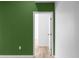 Hallway with a olive green wall with an open door to a neutral wall and light floor at 4219 David Austin Ct, Snellville, GA 30039