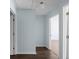 Bright hallway featuring neutral tones, hardwood floors, and multiple doorways at 4219 David Austin Ct, Snellville, GA 30039