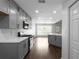 Modern kitchen features stainless steel appliances, gray cabinets, and ample counter space at 4219 David Austin Ct, Snellville, GA 30039