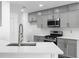 Modern kitchen with stainless steel appliances, quartz countertops, gray cabinets, and subway tile backsplash at 4219 David Austin Ct, Snellville, GA 30039