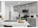 Eat-in kitchen features granite countertops, stainless appliances, and gray cabinets with gold hardware at 4219 David Austin Ct, Snellville, GA 30039
