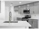 Modern kitchen with gray cabinets, white subway tile backsplash, and quartz countertops at 4219 David Austin Ct, Snellville, GA 30039