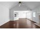 Open living room featuring vaulted ceilings, fireplace, and seamless flow into the adjacent kitchen area at 4219 David Austin Ct, Snellville, GA 30039