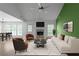 Stylishly furnished living room with fireplace, green accent wall, and open layout at 4219 David Austin Ct, Snellville, GA 30039