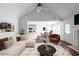 Bright living room with a vaulted ceiling, open layout to dining, and white furniture at 4219 David Austin Ct, Snellville, GA 30039