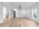 Large open-concept living room with wood flooring, recessed lights, and stairs at 4219 David Austin Ct, Snellville, GA 30039