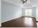This main bedroom features wood floors, light blue walls, and a tray ceiling with ceiling fan at 4219 David Austin Ct, Snellville, GA 30039