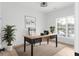 Well-lit home office with modern desk, chair, indoor plants, and natural light at 4219 David Austin Ct, Snellville, GA 30039