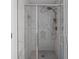 Bright shower with a glass door, marble tiling, and updated fixtures at 4219 David Austin Ct, Snellville, GA 30039