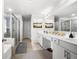 Bathroom featuring double vanity, tiled floor, large mirrors, and glass shower stall at , Atlanta, GA 30349