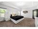 Luxurious bedroom features a statement headboard, tray ceiling, and two large windows at , Atlanta, GA 30349