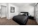 Comfortable bedroom with black platform bed, bedside table, and carpeted floor at , Atlanta, GA 30349