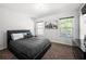 Well-lit bedroom featuring a queen size bed with dark bedding and neutral walls at , Atlanta, GA 30349