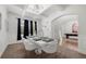 Formal dining room features modern chandelier, large window, and flows into the billiards room, perfect for entertaining at , Atlanta, GA 30349