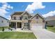 Charming two-story home features a stone and brick facade, a two-car garage, and a well-manicured front yard at , Atlanta, GA 30349