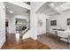Welcoming foyer with hardwood floors, staircase, and an elegant dining area with white table and chairs at , Atlanta, GA 30349