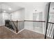 Spacious hallway featuring ornamental wrought iron railing and contemporary lighting at , Atlanta, GA 30349