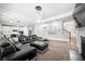 Open living space boasts recessed lighting, dark modern furniture, and a view of a chef's kitchen at , Atlanta, GA 30349