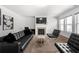 Bright living room with a modern fireplace, and neutral-toned carpet and decor at , Atlanta, GA 30349
