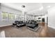 Spacious living room with tray ceiling, large windows, and view into modern kitchen area with stainless appliances at , Atlanta, GA 30349