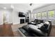 Bright living room featuring fireplace, wet bar and modern black furniture set, with adjacent access to bathroom at , Atlanta, GA 30349