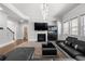 Open concept living room with fireplace, custom lighting, wet bar and access to second story via nearby staircase at , Atlanta, GA 30349