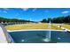 This aerial view shows a pond with a fountain and the green space beyond at 225 Ruby Forest Pkwy, Suwanee, GA 30024