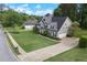 A beautiful two-story home with a large, well-manicured front lawn, showcasing its curb appeal at 225 Ruby Forest Pkwy, Suwanee, GA 30024
