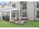 Inviting backyard with a stone fire pit and comfortable seating beneath a pergola at 225 Ruby Forest Pkwy, Suwanee, GA 30024