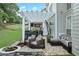 Backyard patio featuring a stone fire pit, outdoor furniture, and covered pergola, ideal for entertaining at 225 Ruby Forest Pkwy, Suwanee, GA 30024