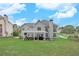 Large backyard with a well-maintained lawn, patio, pergola, and lush greenery at 225 Ruby Forest Pkwy, Suwanee, GA 30024