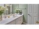 Bathroom featuring a white vanity with gold fixtures and decorative items at 225 Ruby Forest Pkwy, Suwanee, GA 30024
