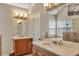 Bathroom featuring double vanity with stone countertop, large mirrors, and walk in shower at 225 Ruby Forest Pkwy, Suwanee, GA 30024