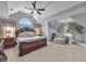 Bright bedroom with vaulted ceiling, large window, and a cozy sitting area at 225 Ruby Forest Pkwy, Suwanee, GA 30024