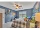 Blue bedroom featuring a cozy bed, guitar, window with blinds and ceiling fan at 225 Ruby Forest Pkwy, Suwanee, GA 30024