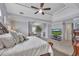 Bright, open primary bedroom featuring a TV and a cozy sitting area at 225 Ruby Forest Pkwy, Suwanee, GA 30024