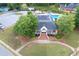 Aerial shot of a clubhouse featuring a welcoming front porch and a neatly maintained lawn at 225 Ruby Forest Pkwy, Suwanee, GA 30024