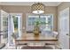 Cozy dining area features a wood table, white chairs, bench seating, and a view to the backyard at 225 Ruby Forest Pkwy, Suwanee, GA 30024