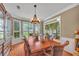 Spacious dining room with hardwood floors, a chandelier, and a full dining set at 225 Ruby Forest Pkwy, Suwanee, GA 30024