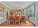 Elegant dining room featuring hardwood floors, chandelier, and lots of natural light from bay windows at 225 Ruby Forest Pkwy, Suwanee, GA 30024