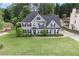 Lovely two-story home with black shutters, landscaping, and a well manicured lawn at 225 Ruby Forest Pkwy, Suwanee, GA 30024