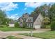 A beautifully landscaped yard complements this home with a detached garage and neutral color palette at 225 Ruby Forest Pkwy, Suwanee, GA 30024