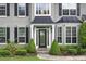 Close up view of home's front entrance, featuring a decorative front door and manicured landscaping at 225 Ruby Forest Pkwy, Suwanee, GA 30024