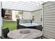 Relaxing hot tub under a pergola, complemented by an outdoor dining set for leisure and entertainment at 225 Ruby Forest Pkwy, Suwanee, GA 30024