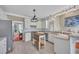 Bright kitchen features white cabinets, stainless steel appliances, a marble countertop and pendant lighting at 225 Ruby Forest Pkwy, Suwanee, GA 30024