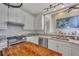 Bright kitchen features white cabinets, stainless steel appliances, a marble countertop and pendant lighting at 225 Ruby Forest Pkwy, Suwanee, GA 30024